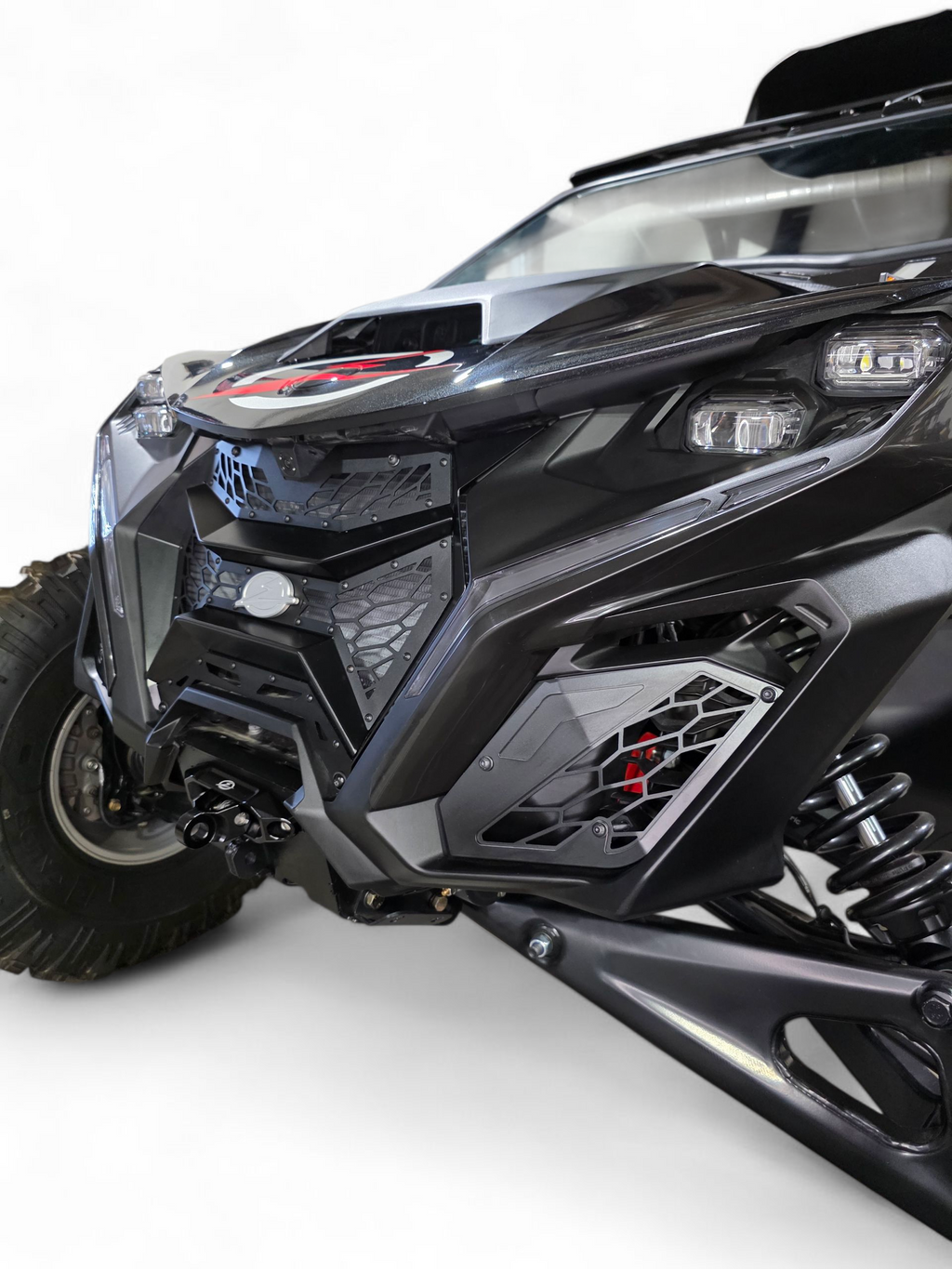 Side angle detail of Volt 3-Piece Grille installed on 2024 Can-Am Maverick R
    showing how grille follows natural body contour lines of front fascia
